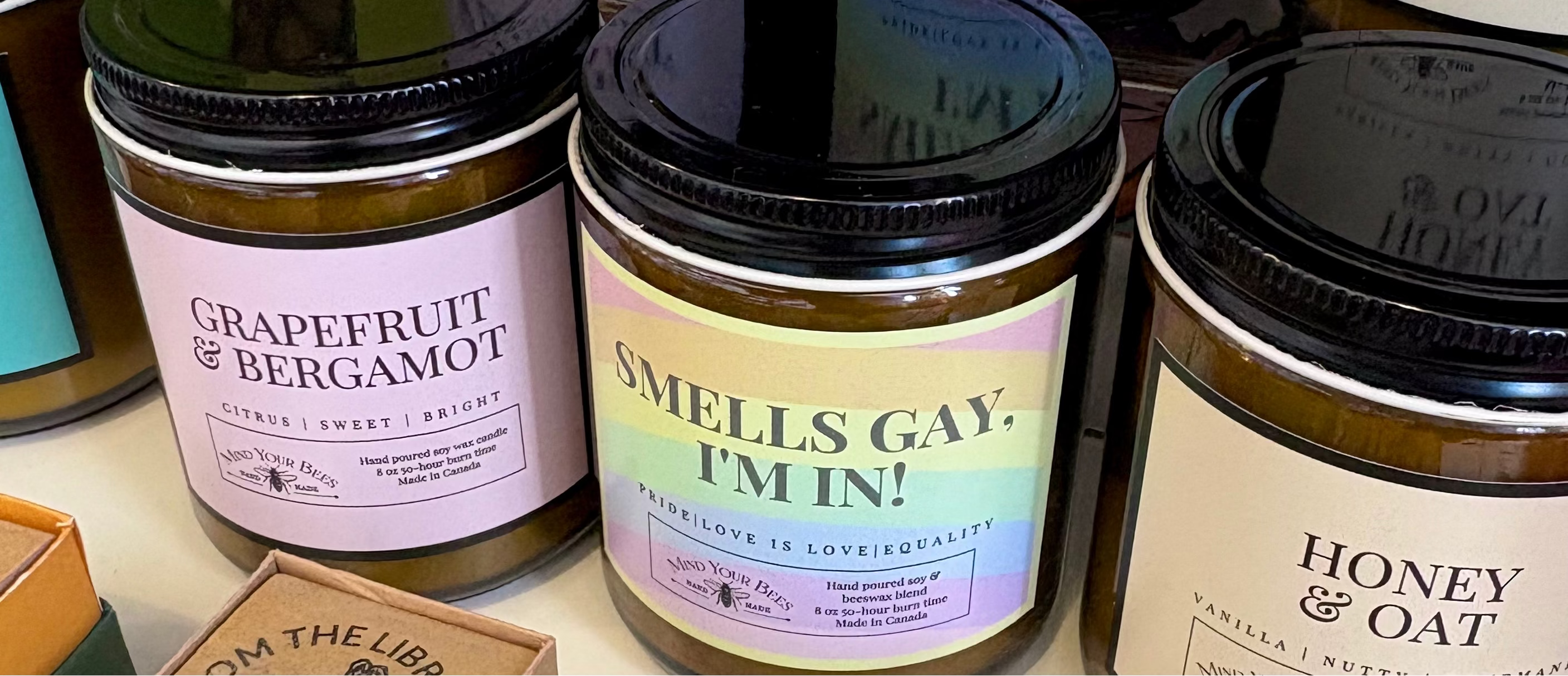 Assorted candles with visible labels on a colorful background